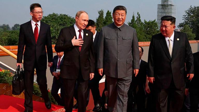 In this pool photograph distributed by the Russian state agency Sputnik, (2nd L-R) Russia’s President Vladimir Putin walks with China’s President Xi Jinping and North Korea’s leader Kim Jong Un before a military parade marking the 80th anniversary of victory over Japan and the end of World War II, in Beijing’s Tiananmen Square on September 3, 2025. (Photo by Alexander KAZAKOV / POOL / AFP)