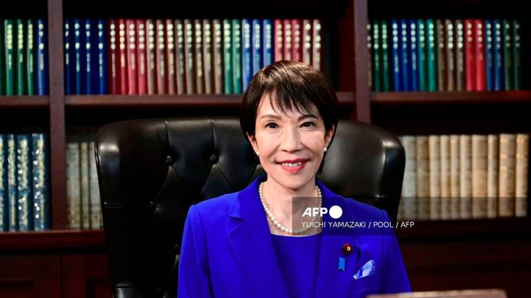 Sanae Takaichi, the newly elected leader of Japan's ruling party, the Liberal Democratic Party (LDP), poses in the party leader's office after the LDP leadership election in Tokyo on October 4, 2025. - POOL via AFP