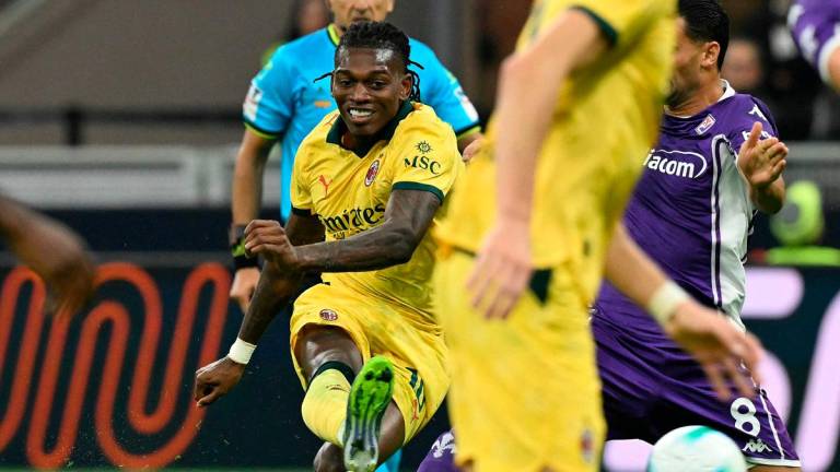 AC Milan’s Portuguese forward #10 Rafael Leao scores his team’s first goal during the Italian Serie A football match between AC Milan and Fiorentina at San Siro stadium in Milan. - Stefano RELLANDINI / AFP
