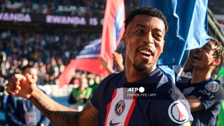Paris Saint-Germain's French defender Presnel Kimpembe celebrates with supporters after the victory at the end of the French L1 football match between Paris Saint-Germain FC and AJ Auxerre at the Parc des Princes stadium in Paris on November 13, 2022. - AFP