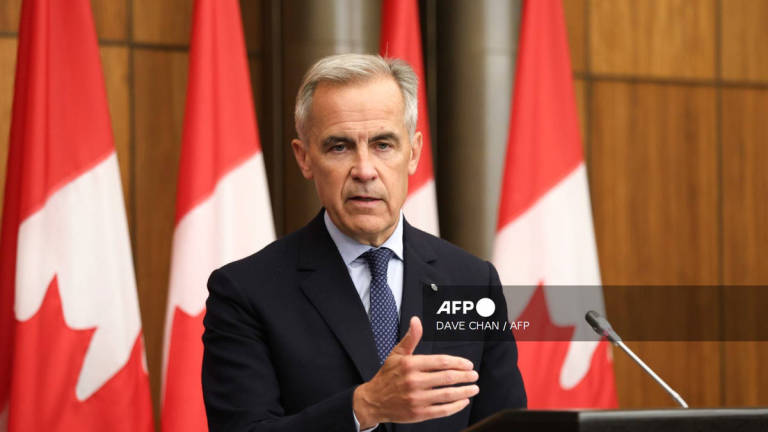 Canadian Prime Minister Mark Carney speaks during a press conference after a Cabinet meeting to discuss both trade negotiations with the US and the situation in the Middle East, at the National Press Theatre in Ottawa, Ontario, Canada on July 30, 2025. - AFP