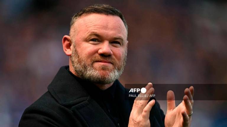 Former Everton player Wayne Rooney arrives on the pitch for the celebrations after the English Premier League football match between Everton and Southampton at Goodison Park in Liverpool, north west England on May 18, 2025, Everton's final premier league fixture played at the stadium, their home since 1892. - AFP