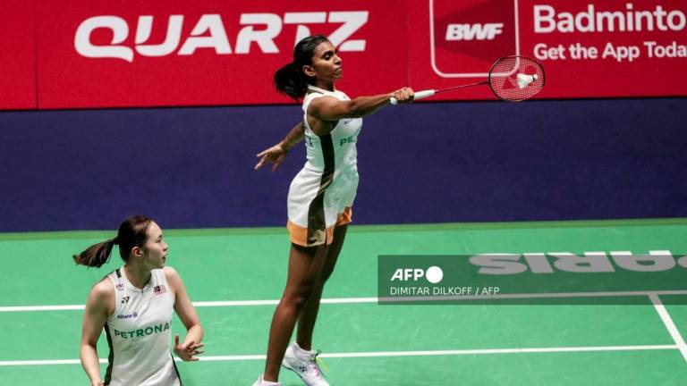 Malaysia's Pearly Tan (bottom) and Thinaah Muralitharan (top) compete against Bulgaria's Gabriela Stoeva and Stefani Stoeva during their women's double match at the Badminton BWF World Championships at the Adidas Arena in Paris, on August 29, 2025. - AFPPIX