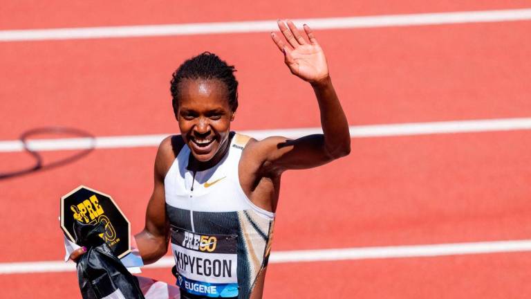 Faith Kipyegon of Kenya waves towards the crowd after winning the Women’s 1500m and setting a new world record during the Prefontaine Classic at Hayward Field on July 5, 2025 in Eugene, Oregon- GETTY IMAGES NORTH AMERICA / AFP