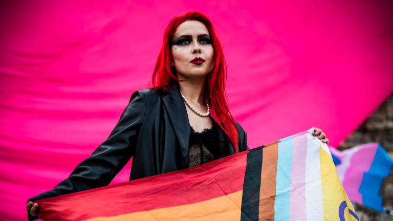 A woman holds a flag during a march after the Hungarian parliament passed a law that bans LGBTQ+ communities from holding the annual Pride march and allows a broader constraint on freedom of assembly, in Budapest, Hungary, March 30, 2025. - REUTERSPIX