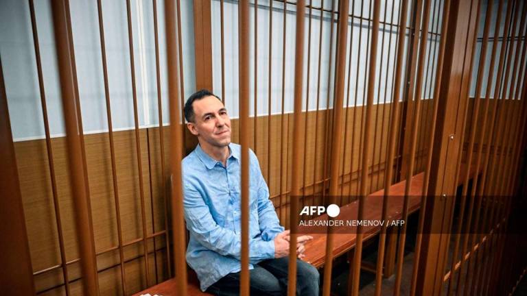 Laurent Vinatier, a French researcher accused of gathering Russian military information without registering as a foreign agent, sits inside a defendants' cage during a hearing in Moscow's Zamoskvoretsky district court on October 14, 2024. - AFP