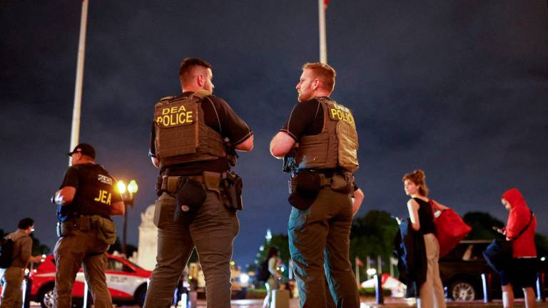 FILE PHOTO: Drug Enforcement Administration (DEA) federal agents patrol outside Union Station, after U.S. President Donald Trump deployed National Guard and ordered an increased presence of federal law enforcement to assist in crime prevention, in Washington, D.C., U.S., August 18, 2025. REUTERS/Jose Luis Gonzalez/File Photo