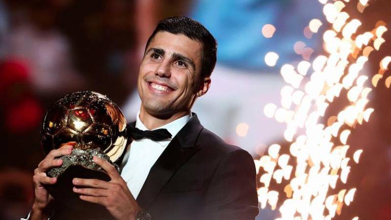 Manchester City's Spanish midfielder Rodri receives the Ballon d'Or award during the 2024 Ballon d'Or France Football award ceremony at the Theatre du Chatelet in Paris on October 28, 2024. - AFPPIX