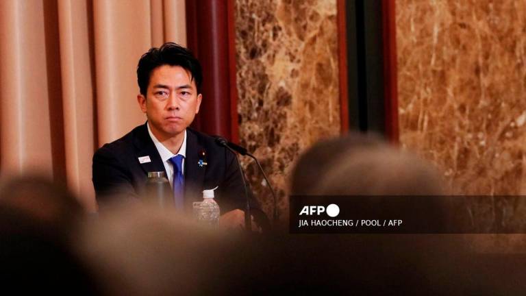Japan's Agriculture Minister Shinjiro Koizumi reacts during the Liberal Democratic Party (LDP) Presidential Election Candidate Debate at Nihon Kisha Club in Tokyo on September 24, 2025. - POOL via AFP