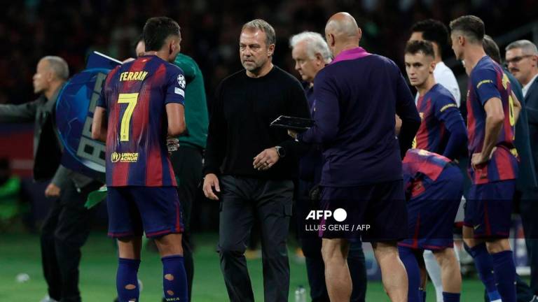 Barcelona's German coach Hans-Dieter Flick (2L) talks to Barcelona's Spanish forward #07 Ferran Torres during the UEFA Champions League league phase day 2 football match between FC Barcelona and Paris Saint-Germain (PSG) at the Estadi Olimpic Lluis Companys in Barcelona, on October 1, 2025. - AFP