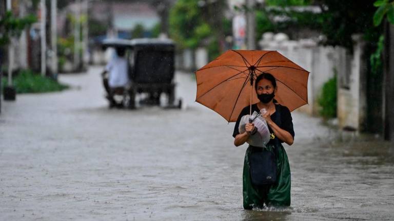 For representational purposes only: A woman wades through a flooded street following rain, intensified by Severe Tropical Storm Matmo, in Santa Lucia, Calumpit, Bulacan province, Philippines, October 3, 2025. REUTERS/Noel Celis
