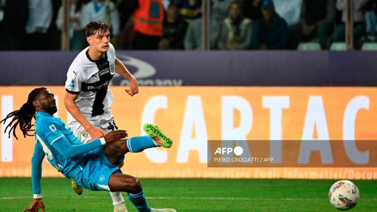Napoli's Cameroon midfielder #99 Andre Zambo Anguissa tries to score despite Parma's Italian defender #46 Giovanni Leoni during the Italian Serie A football match between Parma and Napoli at the Tardini stadium in Parma on May 18, 2025. - AFP
