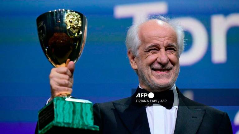 Italian actor Toni Servillo poses with the Coppa Volpi for Best Actor he received for his part in La Grazia (Grace) during the award ceremony of the 82nd Venice Film Festival on September 6, 2025 at Venice Lido. - AFP
