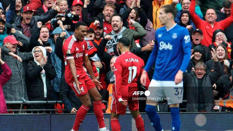 Liverpool's Dutch midfielder #38 Ryan Gravenberch (L) celebrates with Liverpool's Egyptian striker #11 Mohamed Salah (C) after scoring the opening goal of the English Premier League football match between Liverpool and Everton at Anfield in Liverpool, north west England on September 20, 2025. - AFP