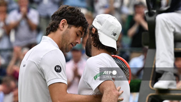 Australia’s Jordan Thompson (R) greets US player Taylor Fritz after withdrawing from their men’s singles fourth round tennis match on the seventh day of the 2025 Wimbledon Championships at The All England Lawn Tennis and Croquet Club in Wimbledon, southwest London, on July 6, 2025. - AFP