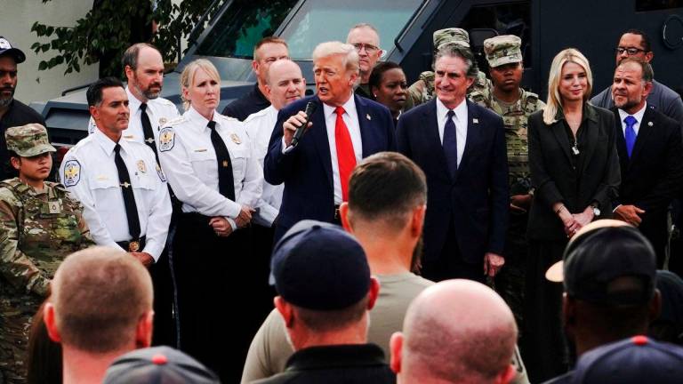 U.S. President Donald Trump speaks as U.S. Attorney General Pam Bondi and U.S. Interior Secretary Doug Burgum stand by his side, while he attends U.S. Park Police Anacostia Operations Facility to meet with police and the military, after deploying National Guard troops in the nation’s capital, in Washington, D.C., U.S., August 21, 2025. REUTERS/Nathan Howard