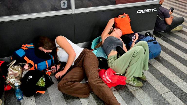 Passengers rest on the floor in the hall of the Main Railway Station, as a major power outage caused train delays, in Prague, Czech Republic, July 4, 2025. - CTK/Vondrous Roman REUTERSPIX