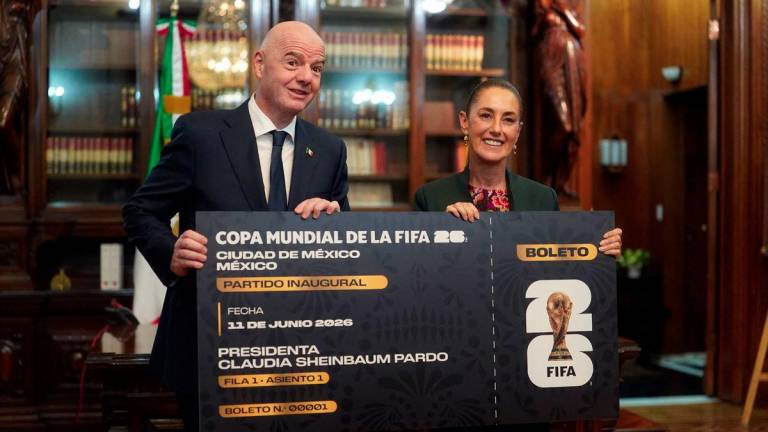 Handout picture released By Mexican Presidency shows Mexico's President Claudia Sheinbaum and FIFA President Gianni Infantino pose for pictures with a giant ticket at the National Palace in Mexico City on August 28, 2025. Mexico is co-hosting the 2026 FIFA World Cup with US and Canada. - AFPPIX/Mexican Presidency/Handout