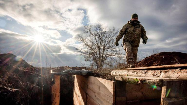 Ukrainian military engineer with the callsign Lynx inspects a freshly dug trench that his unit built as part of a system of new fortifications near the front lines outside Kupiansk, amid Russia's attack on Ukraine, December 28, 2023. - REUTERSPIX