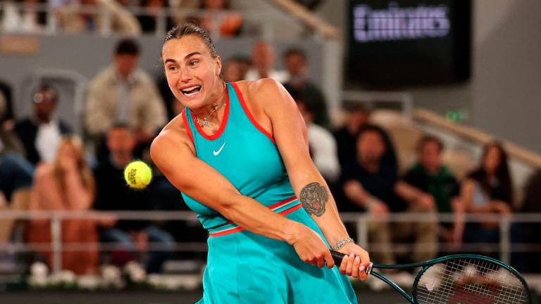 Belarus’ Aryna Sabalenka plays a backhand return to Poland’s Iga Swiatek during their women’s singles semi-final match on day 12 of the French Open tennis tournament on Court Philippe-Chatrier at the Roland-Garros Complex in Paris on June 5, 2025.