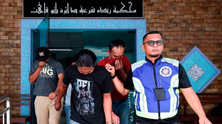Three men (from left), Muhammad Suhail Suttrysono, 35, Anuar Bandi, 40, and Azman Mohamed Seh, 45, pleaded guilty at the Syariah Court here today to charges of being involved in a worship ceremony linked to the viral video “Show Puja Jin Batu Pahat,“ which featured the kuda kepang dance in Parit Raja here three weeks ago. - BERNAMA