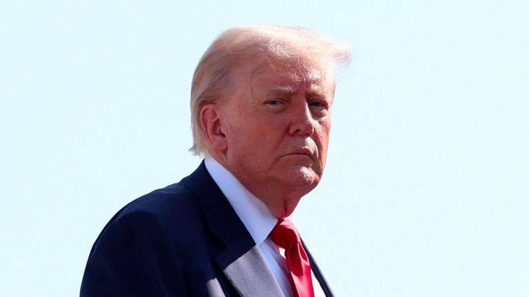 U.S. President Donald Trump boards Air Force One, as he departs for Scotland, at Joint Base Andrews, Maryland, U.S., July 25, 2025. - REUTERSPIX