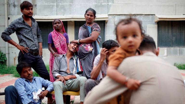 Kalpeshbhqi Patni, 28, mourns as he sits outside the postmortem room at a hospital, for his brother Akash Patni, 14, who died when an Air India Boeing 787-8 Dreamliner plane crashed during take-off from an airport, in Ahmedabad, India, June 13, 2025. - REUTERSPIX