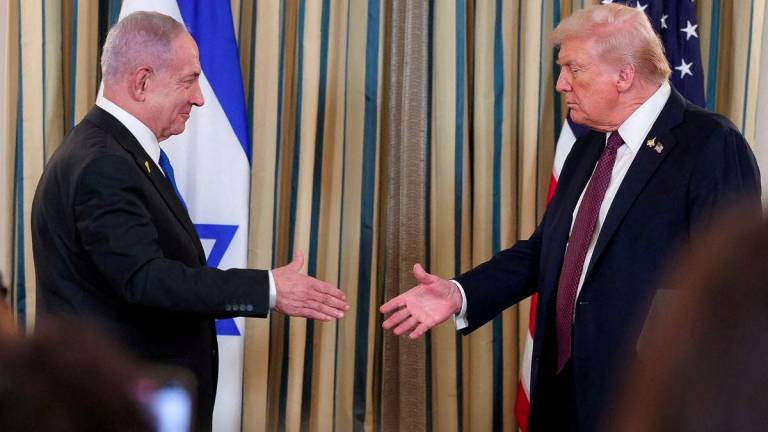 U.S. President Donald Trump and Israeli Prime Minister Benjamin Netanyahu reach to shake hands at a joint press conference in the State Dining Room at the White House in Washington, D.C., U.S., September 29, 2025. - REUTERSPIX