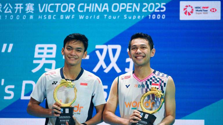 Indonesia’s Fajar Alfian (R) and Muhammad Shohibul Fikri celebrate after winning the men’s doubles final against Malaysia’s Aaron Chia and Soh Wooi Yik at the China Open badminton tournament in Changzhou, in China’s eastern Jiangsu province on July 27, 2025. (Photo by AFP)