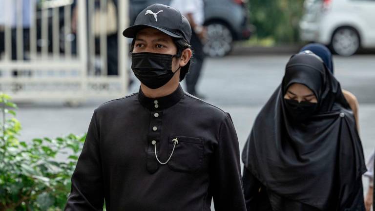 Parents to autistic child Zayn Rayyan Abdul Matiin, Ismanira Abdul Manaf (right) and Zaim Ikhwan Zahar at the Petaling Jaya Sessions Court during an earlier hearing. - Bernama pix