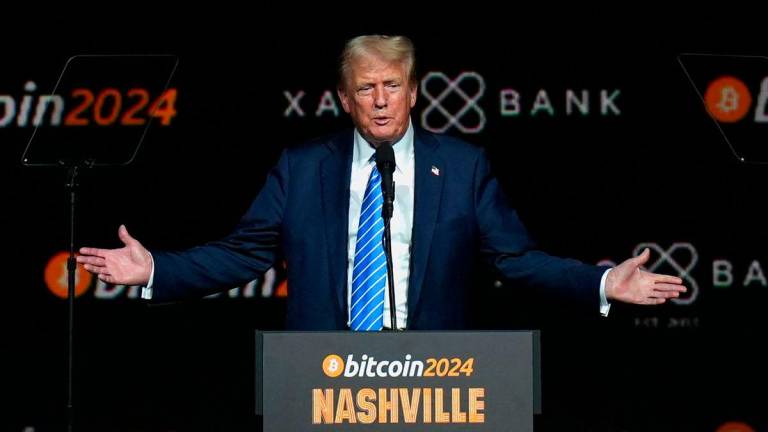 FILE PHOTO: Republican presidential nominee and former U.S. President Donald Trump gestures at the Bitcoin 2024 event in Nashville, Tennessee, U.S., July 27, 2024. REUTERS/Kevin Wurm/File Photo