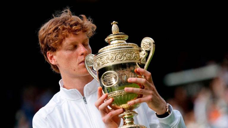FILE PHOTO: Italy’s Jannik Sinner celebrates with the trophy after winning the Wimbledon men’s final against Spain’s Carlos Alcaraz in London, July 13, 2025. REUTERS/Stephanie Lecocq/File Photo