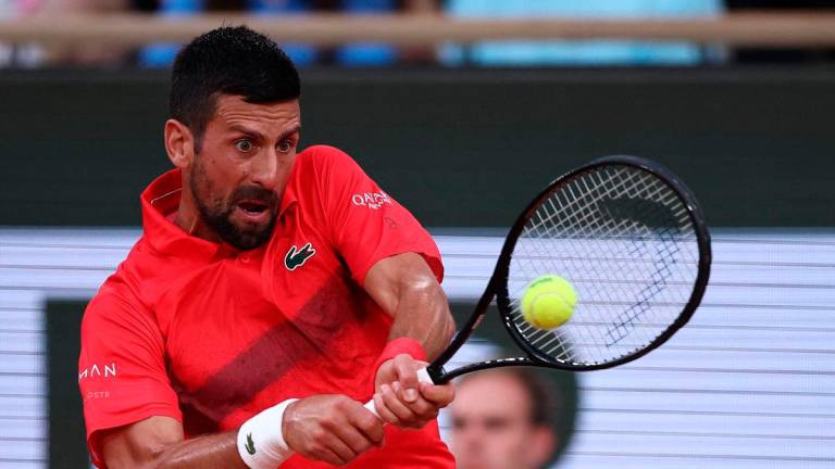 Djokovic beats Misolic at Roland Garros while fans cheer PSG’s UCL win; Serb jokes about missing the 5-0 final and Paris celebrations. AFPpix