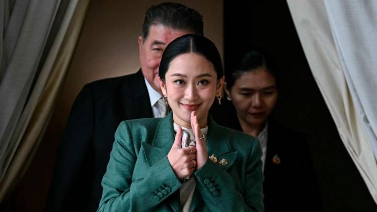 Thailand’s Prime Minister Paetongtarn Shinawatra arrives for a press conference following her suspension by the country’s Constitutional Court at Government House in Bangkok on July 1, 2025. (Photo by Lillian SUWANRUMPHA / AFP)