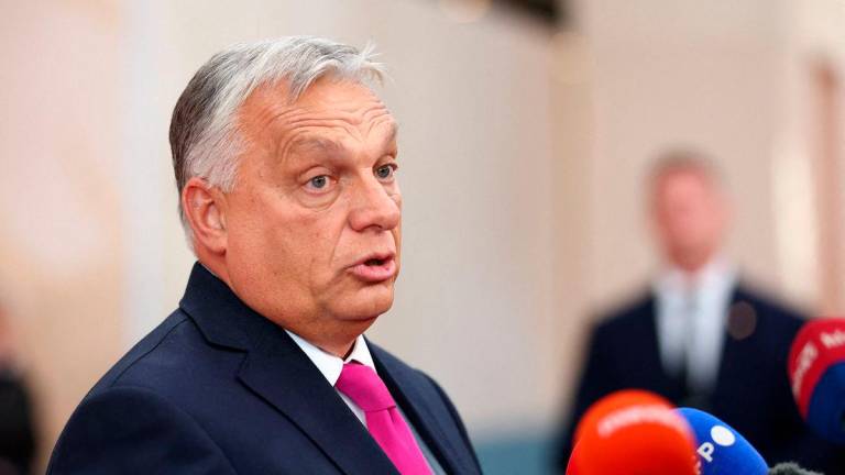 FILE PHOTO: Hungarian Prime Minister Victor Orban speaks to members of the media at the European Political Community summit in Copenhagen, Denmark, October 2, 2025. REUTERS/Piroschka van de Wouw/File Photo