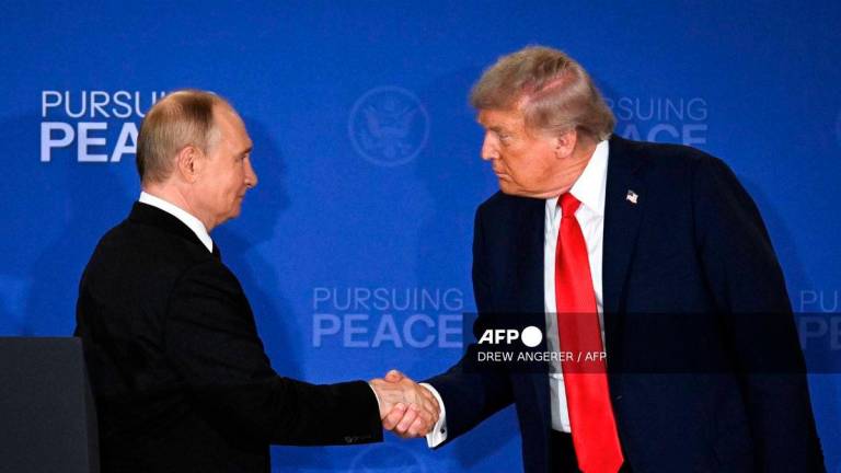 US President Donald Trump (R) and Russian President Vladimir Putin shake hands at the end of a joint press conference after participating in a US-Russia summit on Ukraine at Joint Base Elmendorf-Richardson in Anchorage, Alaska, on August 15, 2025. Photo by DREW ANGERER / AFP