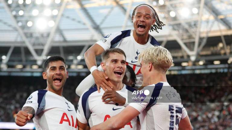 Tottenham Hotspur's Dutch defender #37 Micky van de Ven (C) celebrates scoring their third goal with Tottenham Hotspur's Swedish midfielder #15 Lucas Bergvall (R), Tottenham Hotspur's Argentinian defender #17 Cristian Romero (L) and Tottenham Hotspur's Dutch midfielder #07 Xavi Simons (top) during the English Premier League football match between West Ham United and Tottenham Hotspur at the London Stadium, in London on September 13, 2025. - AFP