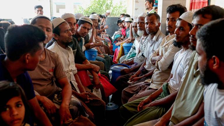 Rohingya refugees wait at the World Food Programme(WFP) distribution center to purchase grocery items, at the refugee camp in Cox's Bazar, Bangladesh, March 15, 2025. - REUTERSPIX