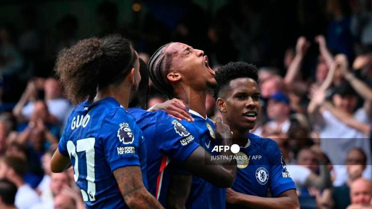 Chelsea's Brazilian striker #20 Joao Pedro (C) celebrates with teammates after scoring the opening goal during the English Premier League football match between Chelsea and Fulham at Stamford Bridge in London on August 30, 2025. - AFP