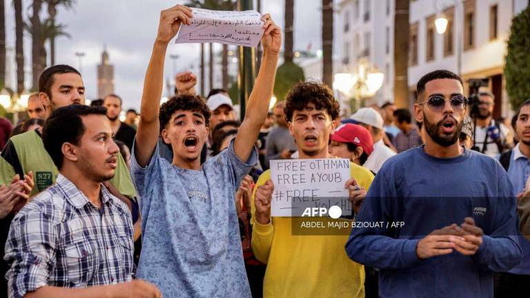 Demonstrators chant slogans during a protest called for by the self-styled GenZ212 collective demanding reforms to public healthcare and education in Rabat for the eighth consecutive day on October 3, 2025. - AFP
