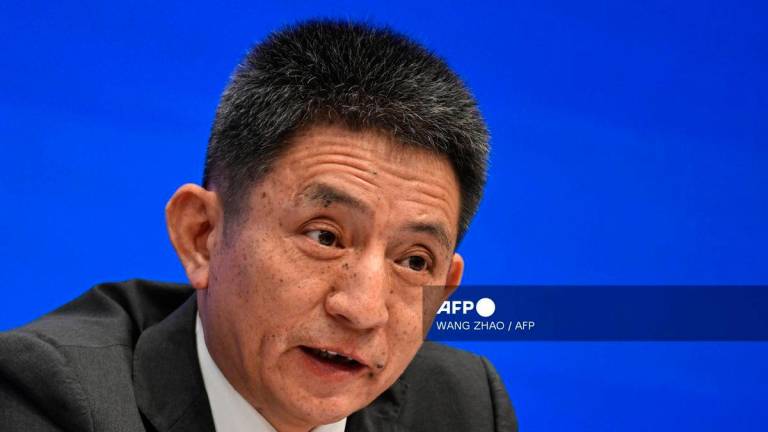 Li Chenggang, China’s International Trade Negotiator and Vice Minister of Commerce, speaks during a press conference in Beijing on July 18, 2025. (Photo by WANG Zhao / AFP)