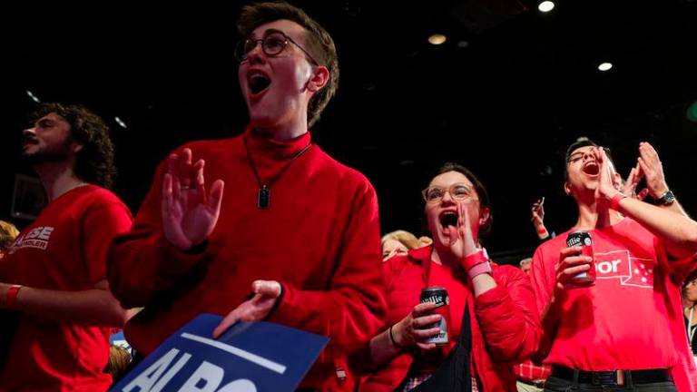 Supporters of Australia's Prime Minister Anthony Albanese react at a Labor party election night event, after local media projected the Labor Party's victory, on the day of the Australian federal election, in Sydney, Australia, May 3, 2025. - REUTERSPIX