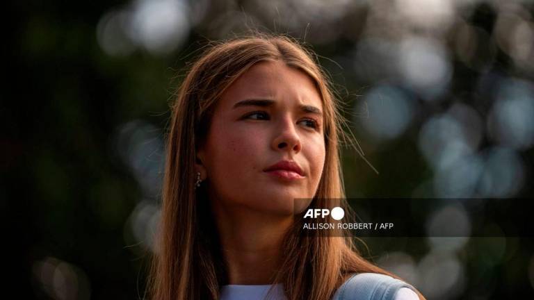 US President Donald Trump’s granddaughter Kai Trump looks on as Trump speaks to the press outside of the White House in Washington, DC, on September 26, 2025 ahead of a trip to the Ryder Cup in Bethpage, New York. (Photo by Allison ROBBERT / AFP)