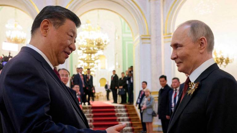 FILE PHOTO: Russian President Vladimir Putin shakes hands with Chinese President Xi Jinping during a reception, held on Victory Day marking the 80th anniversary of the victory over Nazi Germany in World War Two, at the Kremlin in Moscow, Russia, May 9, 2025. Sputnik/Mikhail Metzel/Pool via REUTERS