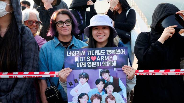 FILE PHOTO: BTS fans wait for BTS members Jungkook and Jimin who are set to be discharged from South Korea?s mandatory military service, in Yeoncheon, South Korea, June 11, 2025. REUTERS/Kim Hong-Ji/File Photo