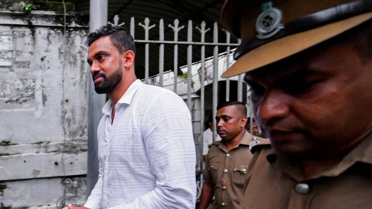 Former Sri Lanka spin bowler Sachithra Senanayake (L) is taken to a prison in Colombo September 6, 2023. Former spin bowler Sachithra Senanayake was on September 6, arrested on allegations of match-fixing under a Sri Lankan law aimed at stamping out corruption in cricket in the country. (Photo by Ishara S. KODIKARA / AFP)