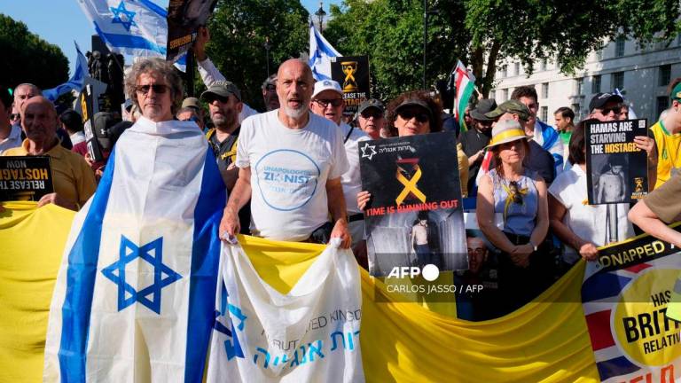 People hold flags and banners during a ‘National march for the Hostages’ organised by Stop the Hate UK, in central London on August 10, 2025. (Photo by CARLOS JASSO / AFP)