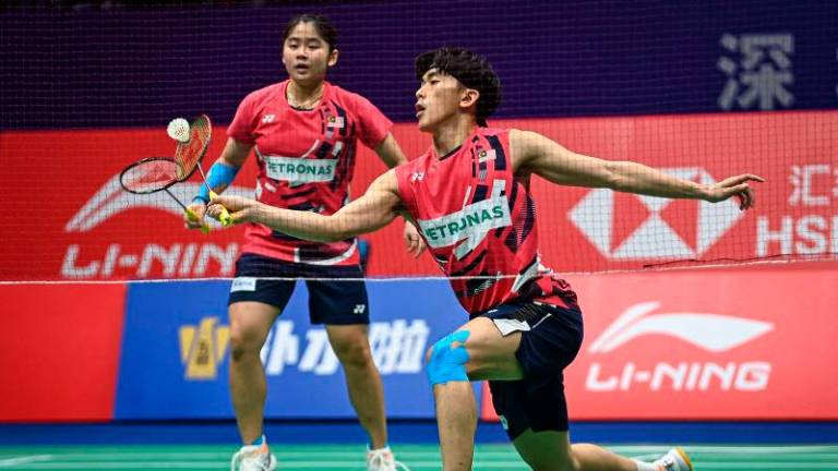 Malaysia’s Hoo Pang Ron (R) and Cheng Su Yin play against Hong Kong’s Tang Chun Man and Tse Ying Suet during the mixed doubles semi-final match of the BWF World Tour China Masters 2024 badminton tournament in Shenzhen, in southern China’s Guangdong province on November 23, 2024. - AFPPIX