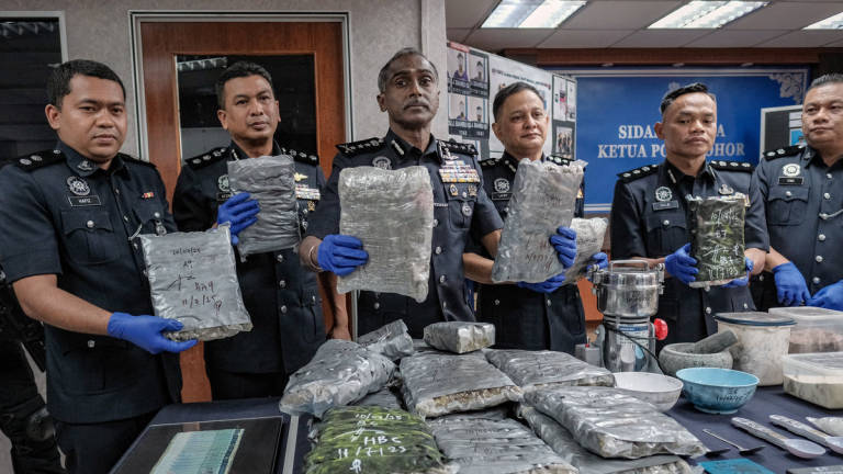 Johor Police Chief Datuk M. Kumar (third from left) shows the seized marijuana during a press conference on the success of drug seizures and the crackdown on criminal activities through Operation Bugil at the Johor Police Contingent Headquarters (IPK) today. - BERNAMA