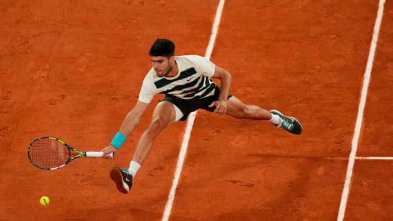 Spain’s Carlos Alcaraz plays a forehand return to Italy’s Lorenzo Musetti during their men’s singles semi-final match on day 13 of the French Open tennis tournament on Court Philippe-Chatrier at the Roland-Garros Complex in Paris on June 6, 2025. AFP